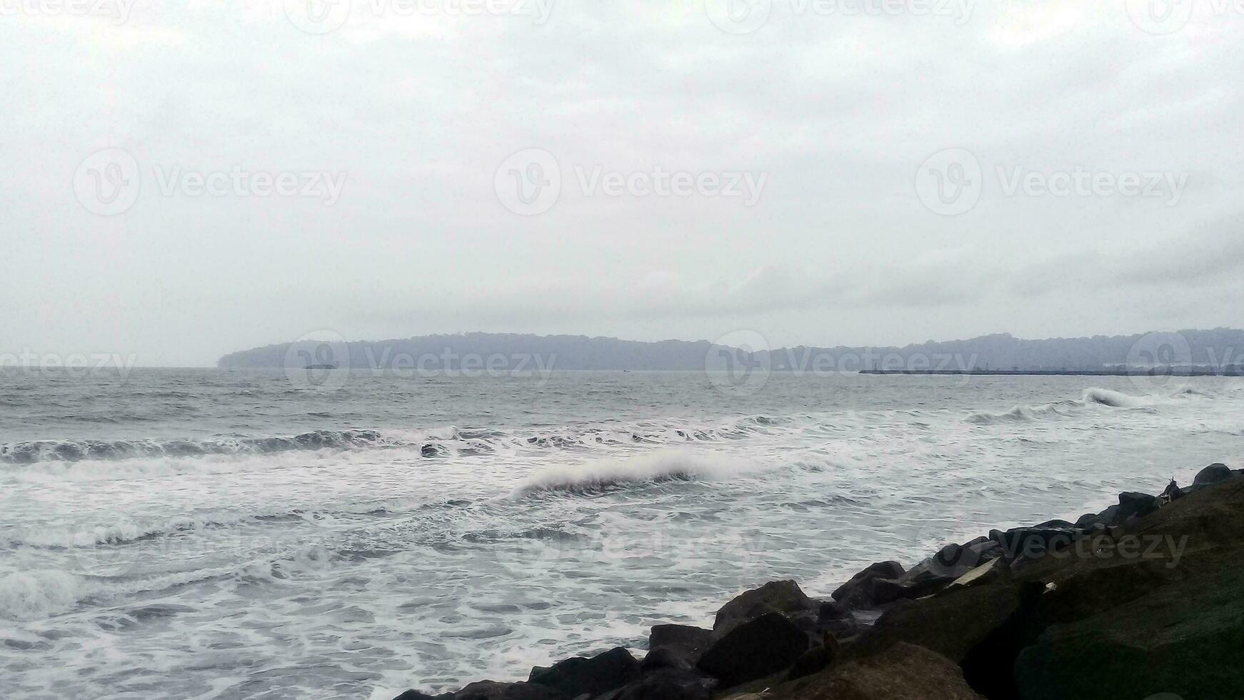 View of the waves and rocks on the beach photo