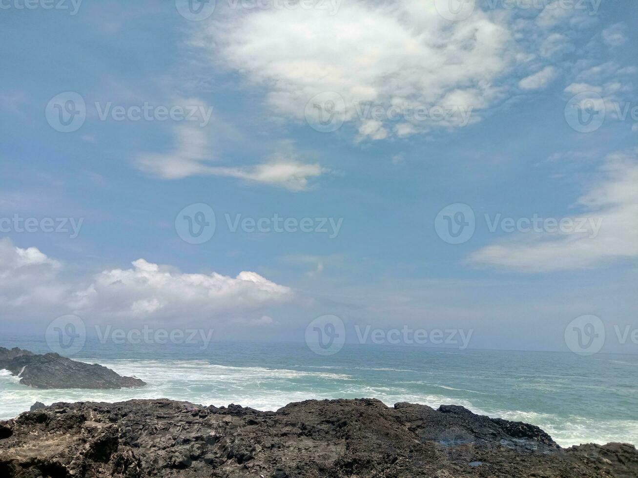 View of the waves and rocks on the beach photo