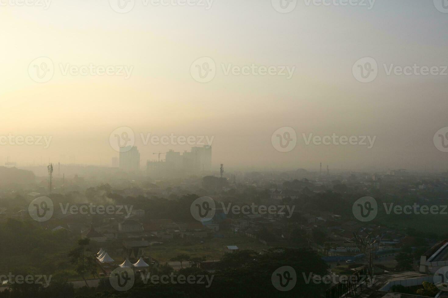 The view of the sunrise in the middle of the city seen from above photo