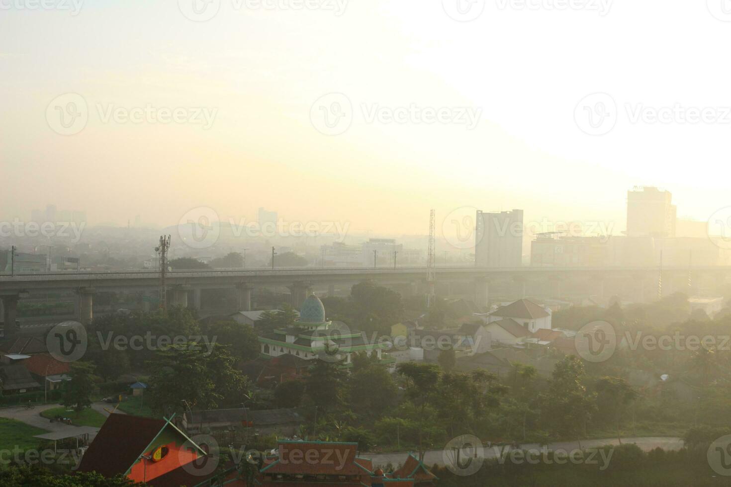 The view of the sunrise in the middle of the city seen from above photo