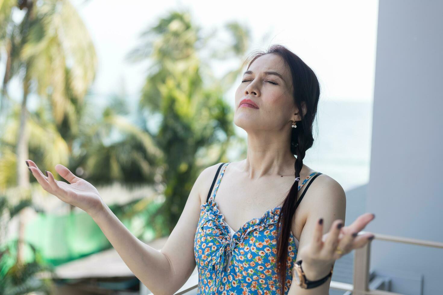 a woman is praying with her eyes closed. photo