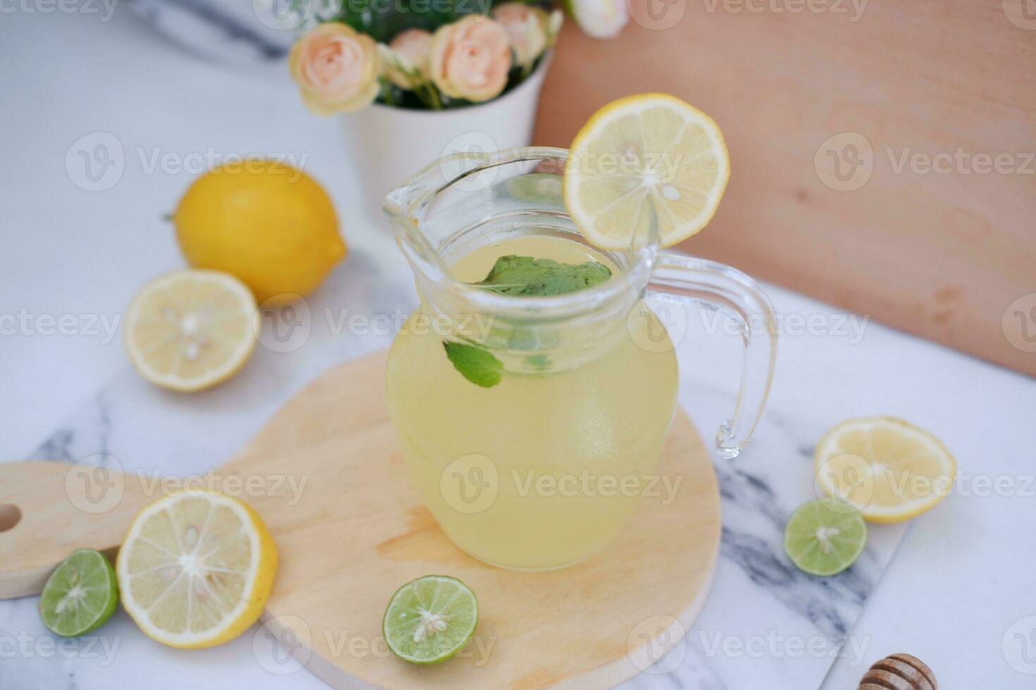 Lemonade with fresh lemon and mint leaves on a white background photo