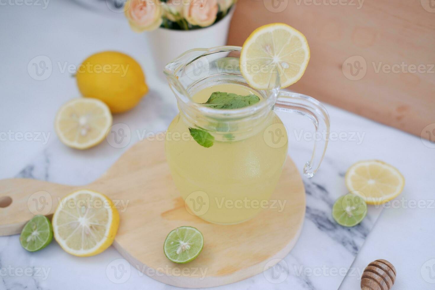 Lemonade with fresh lemon and mint leaves on a white background photo