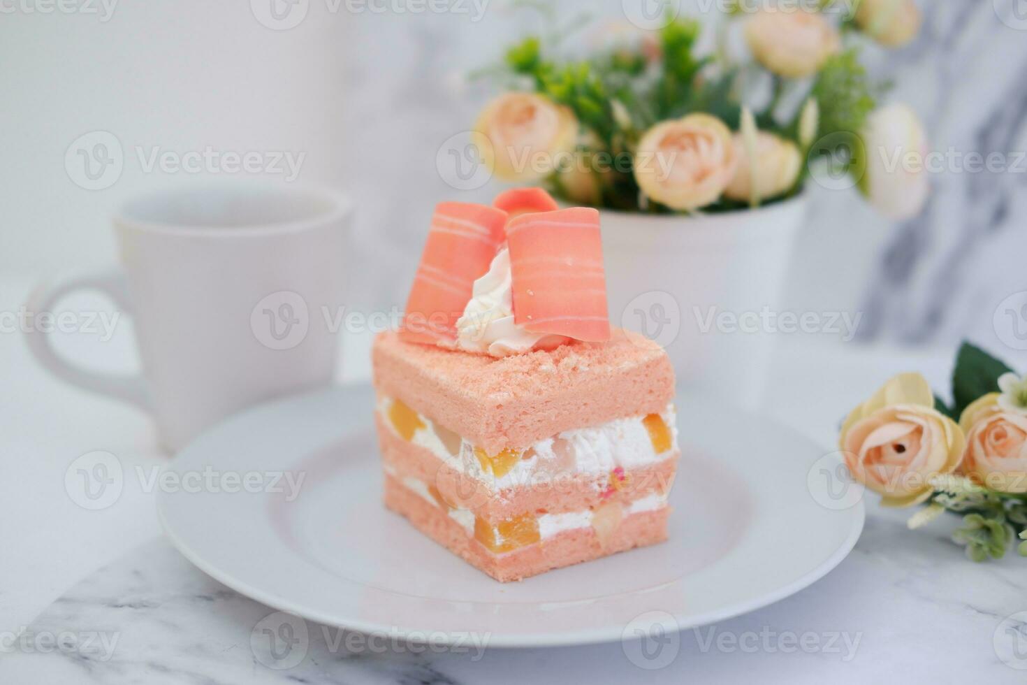 Slice of cake on white marble background. Selective focus. photo
