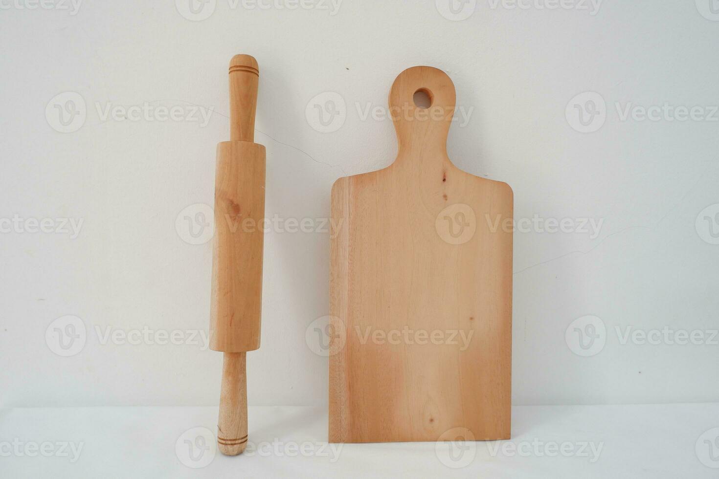 Wooden cutting board and rolling pin isolated on white background