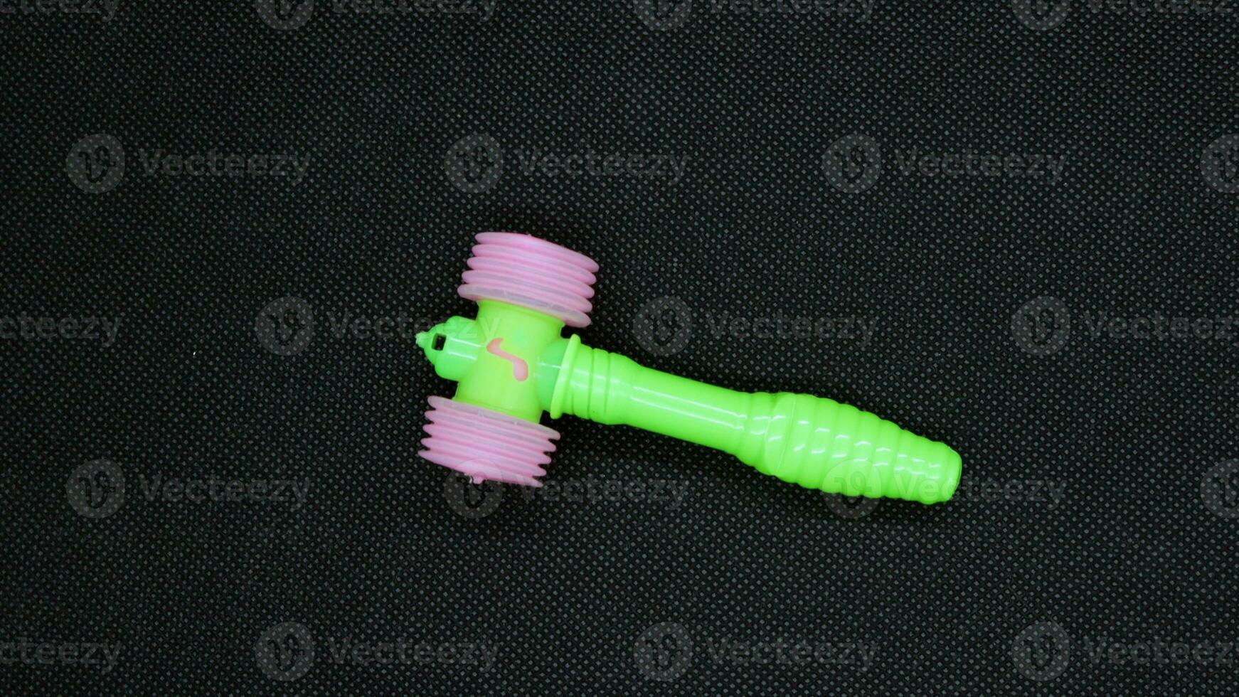 Green little hammer toy for kids photo