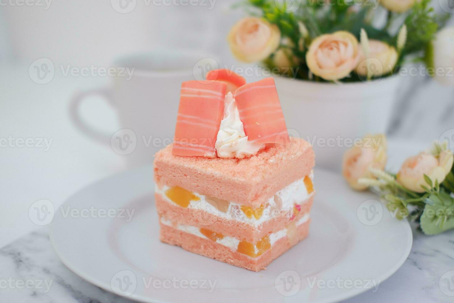 Slice of cake on white marble background. Selective focus. photo