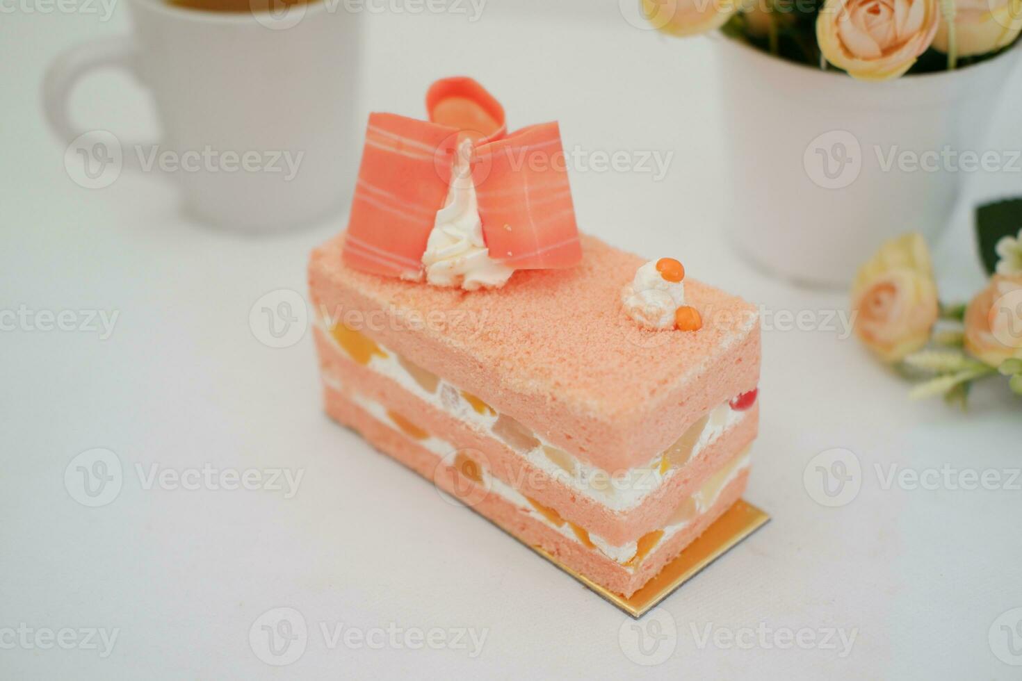 Slice of cake on white marble background. Selective focus. photo