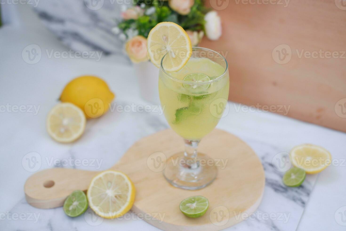 Lemonade with lime, mint and ice on a white background photo