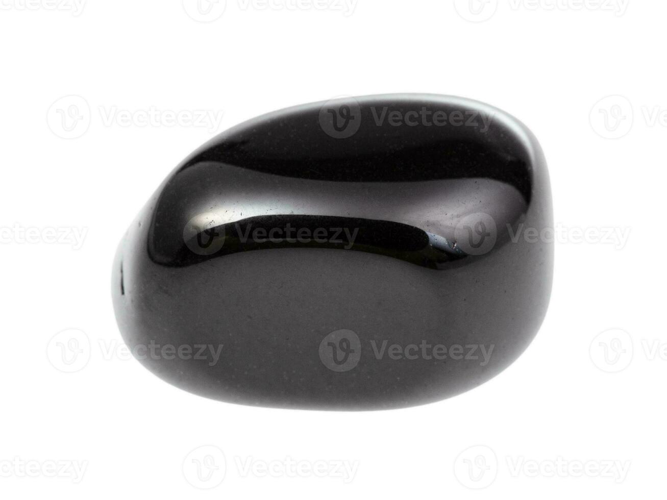 tumbled black onyx gemstone isolated on white photo