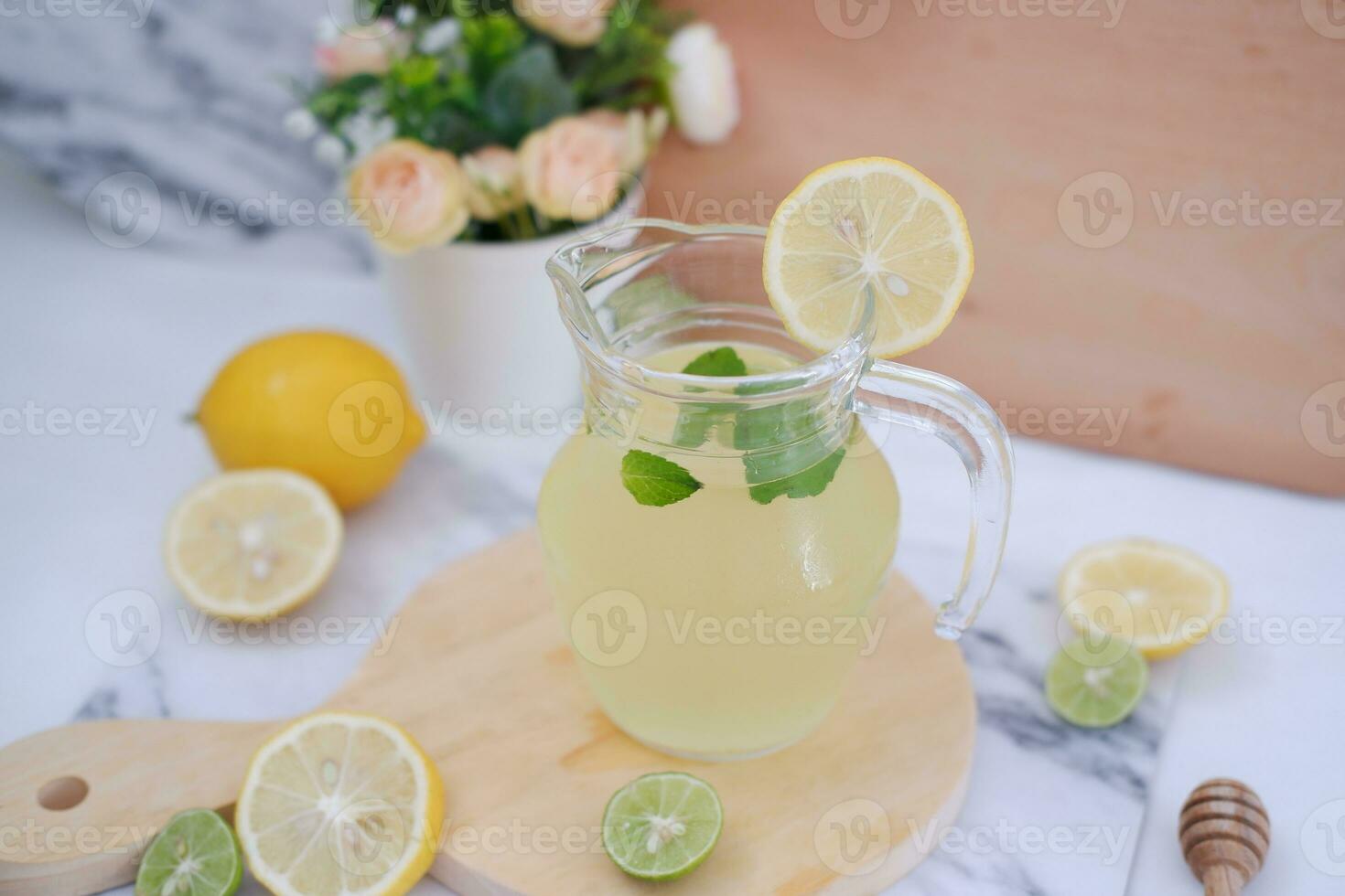 Lemonade with fresh lemon and mint leaves on a white background photo