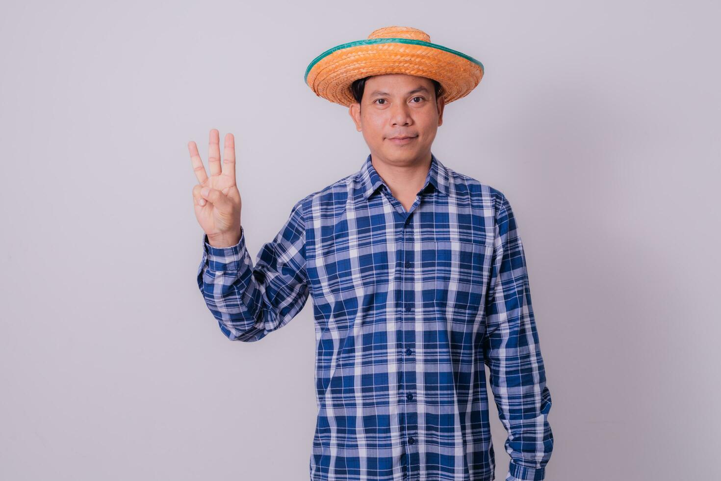 Asian farmer wearing striped shirt photo