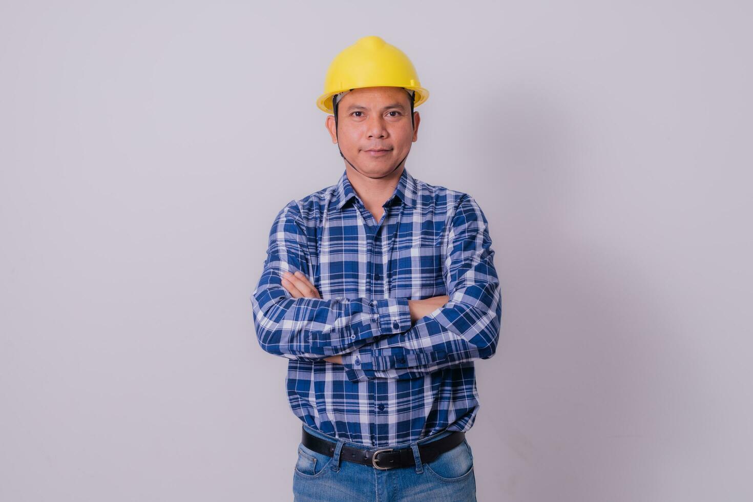 Asian engineer in striped shirt on white background photo