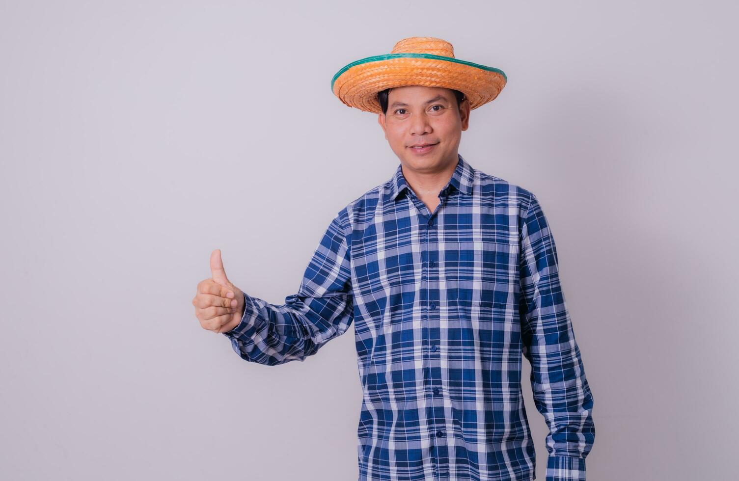 Asian farmer wearing striped shirt photo