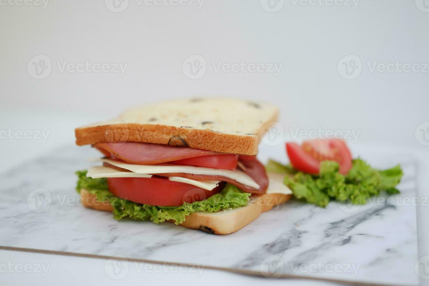 Sandwich with ham, cheese, tomato and lettucele background photo