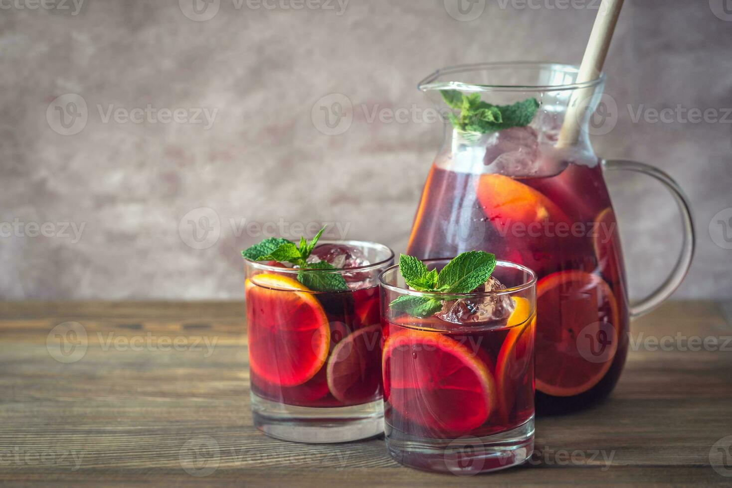 A pitcher and two glasses with Spanish fruit Sangria photo