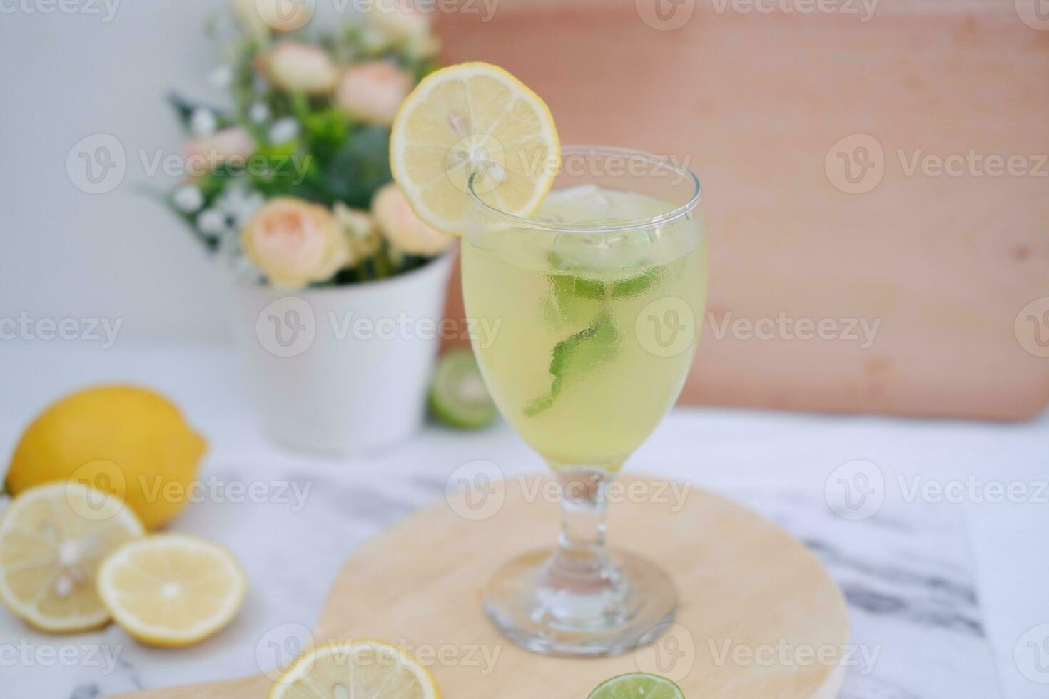 Lemonade with lime, mint and ice on a white background photo