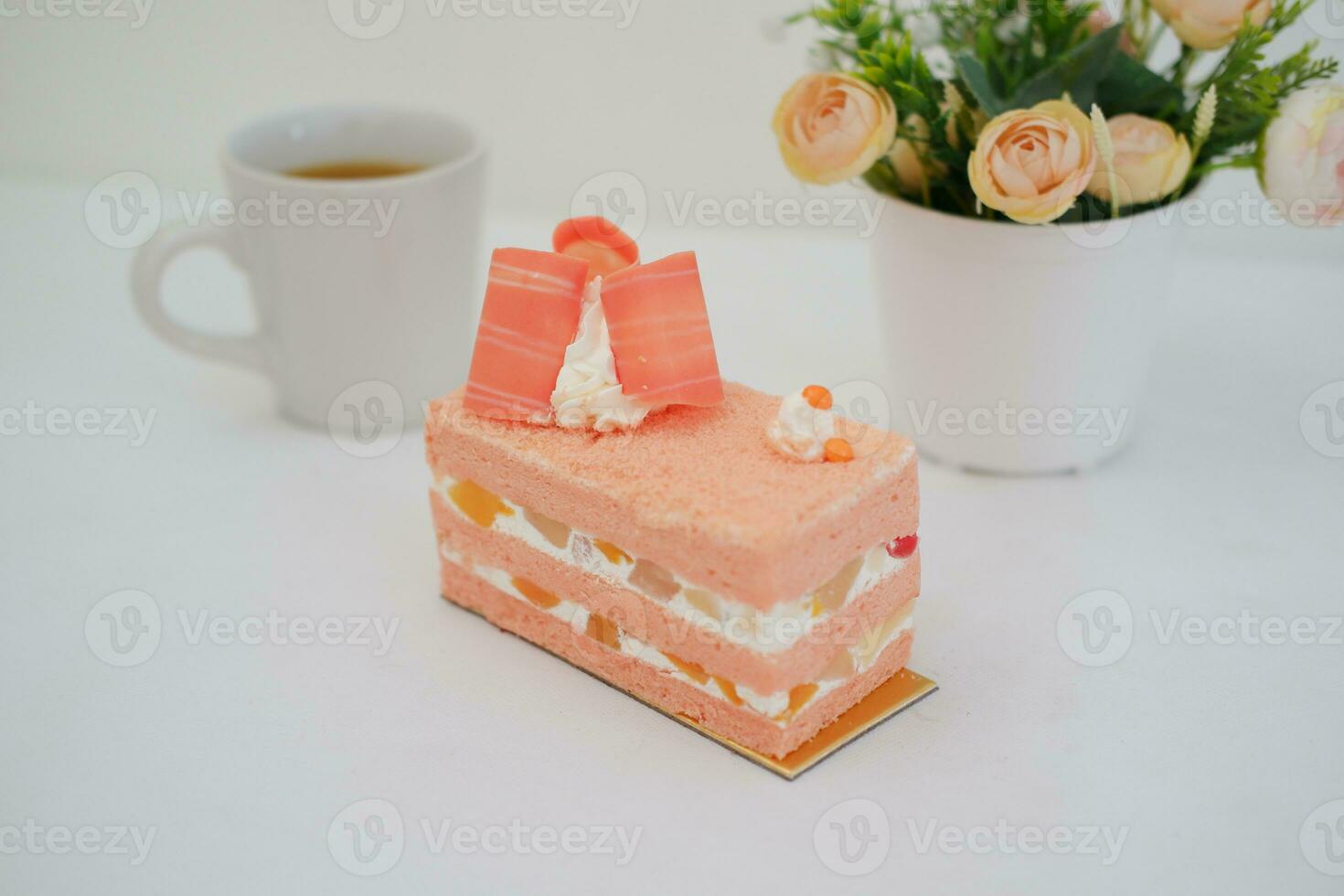 Slice of cake on white marble background. Selective focus. photo