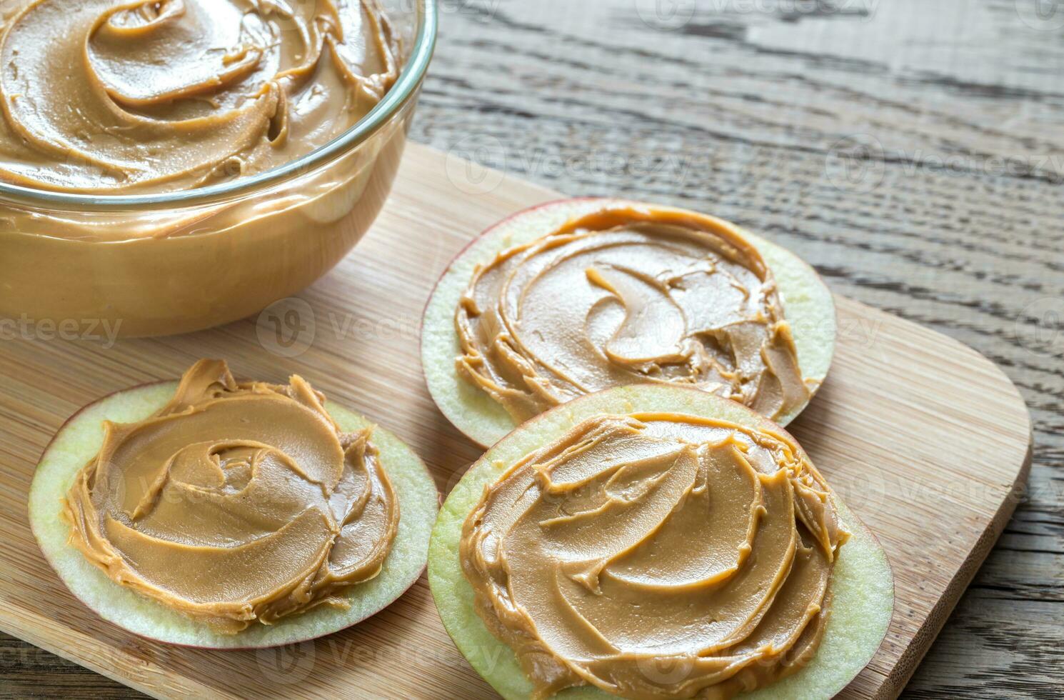 Slices of apples with peanut butter photo