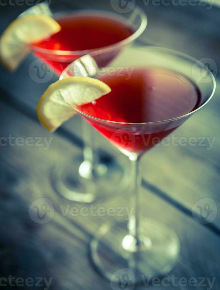 Two cosmopolitan cocktails on the wooden background photo