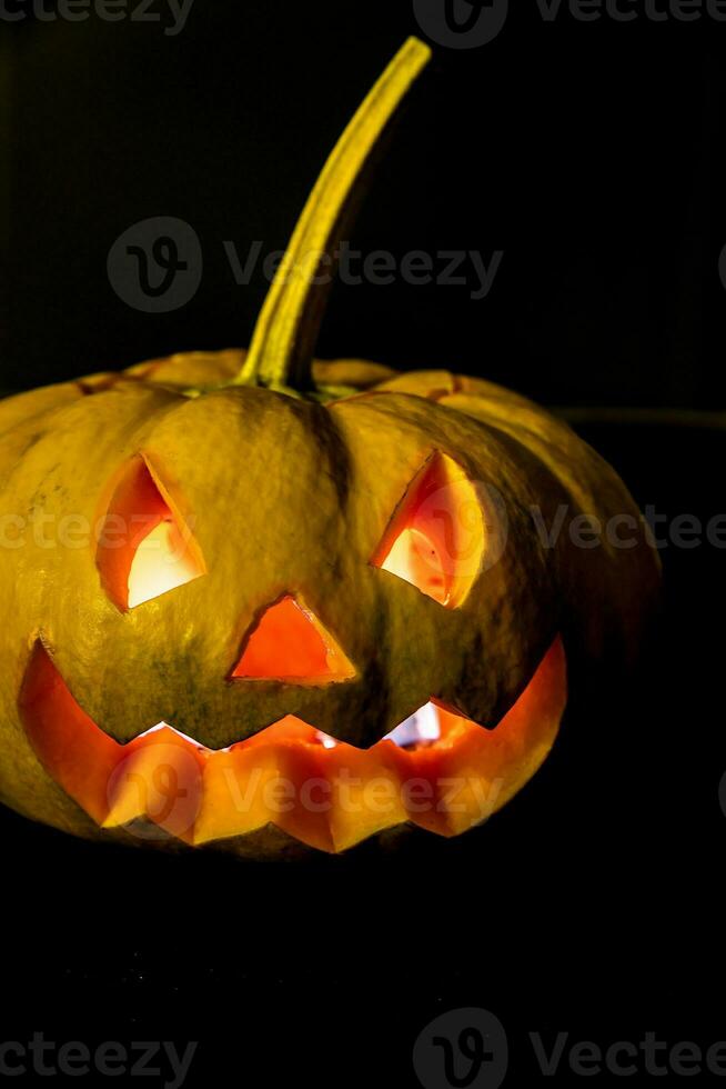 Glowing halloween pumpkin in candlelight photo