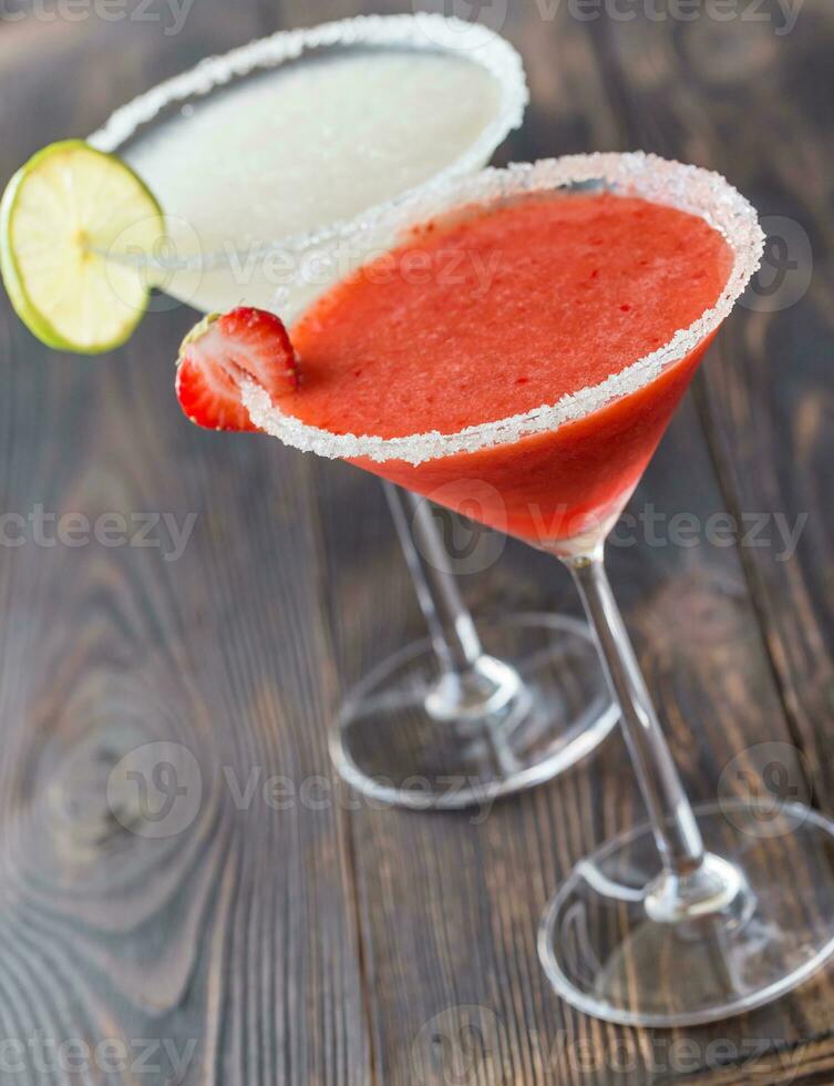 Glasses of lime and strawberry margarita cocktail photo