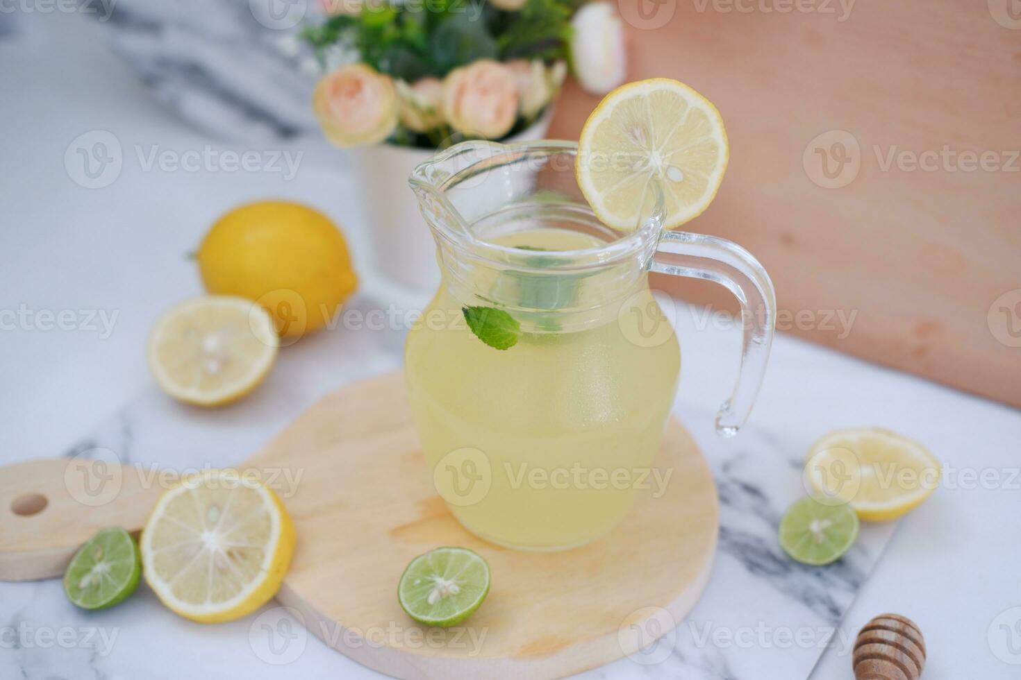 Lemonade with fresh lemon and mint leaves on a white background photo