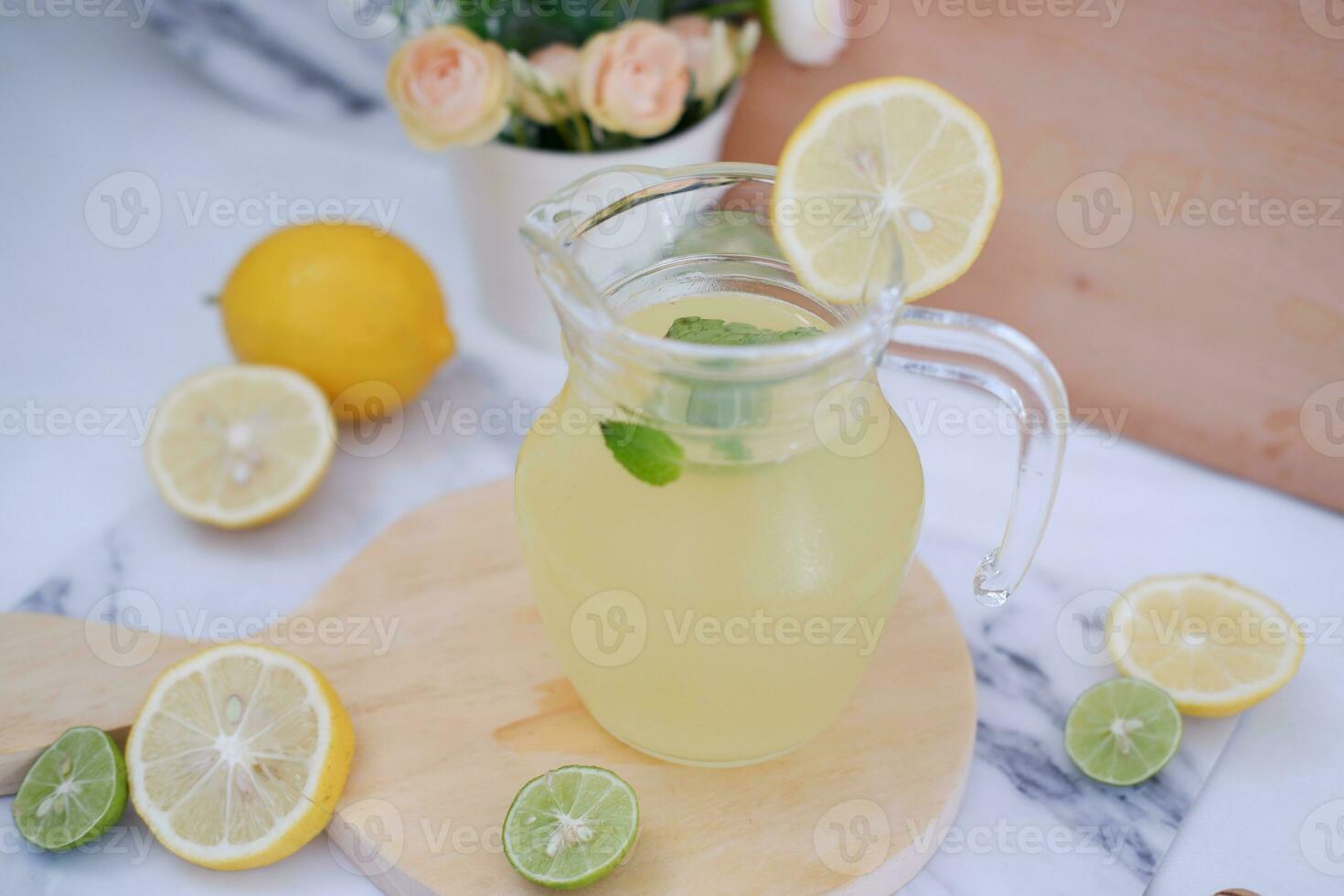 Lemonade with fresh lemon and mint leaves on a white background photo