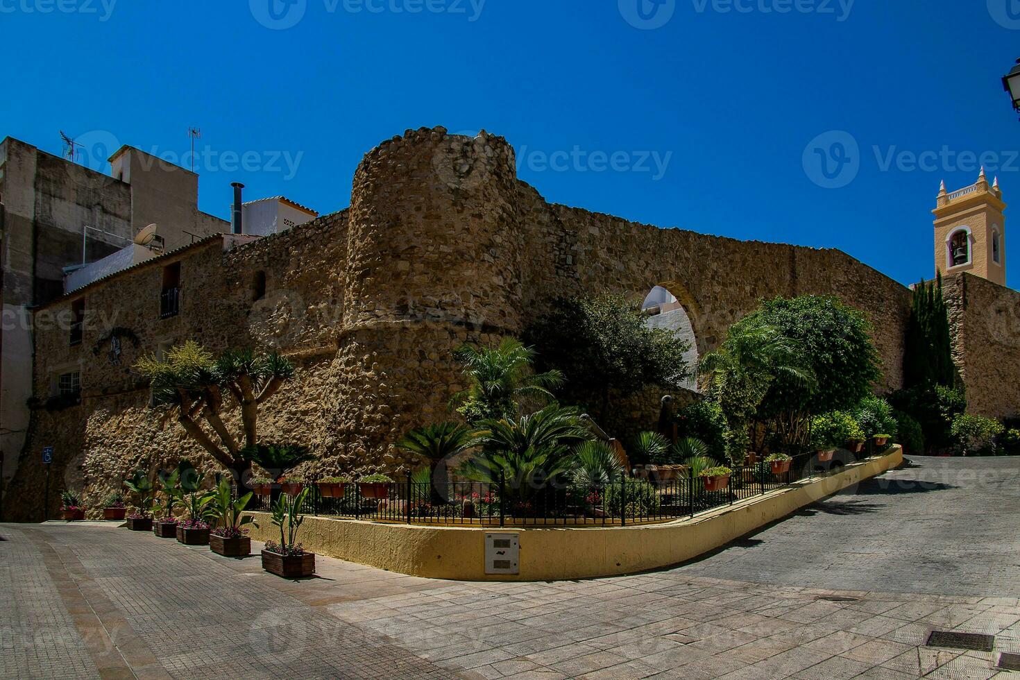 narrow streets of the old town in Calpe Spain on a summer hot holiday day photo