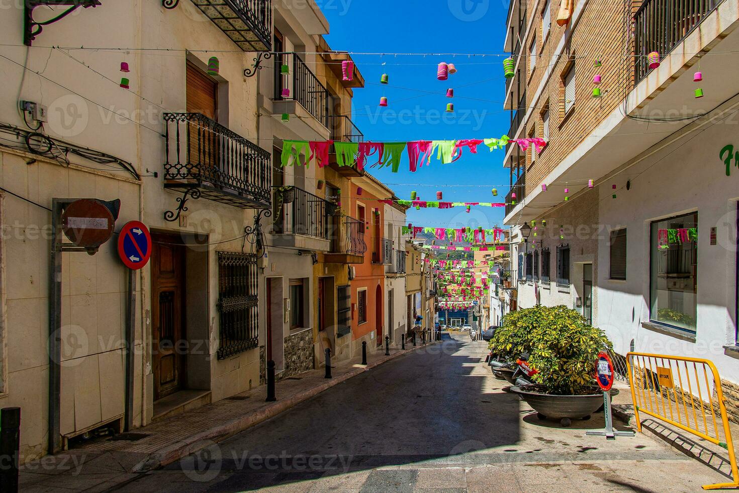 narrow streets of the old town in Calpe Spain on a summer hot holiday day photo