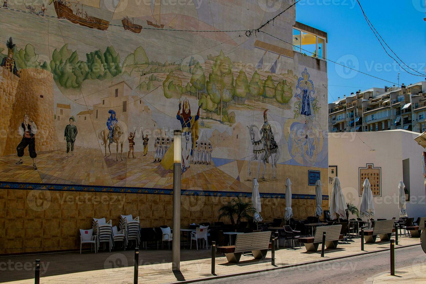 narrow streets of the old town in Calpe Spain on a summer hot holiday day photo