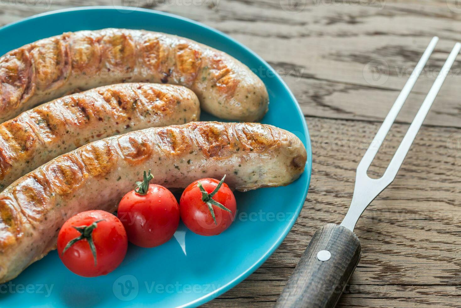 Grilled sausages with cherry tomatoes photo