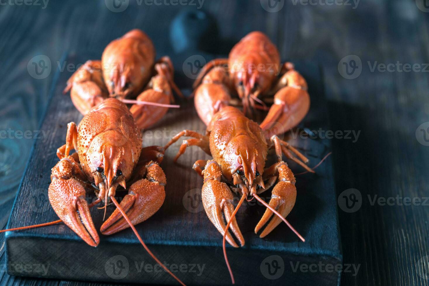 Boiled crayfish on the wooden board photo