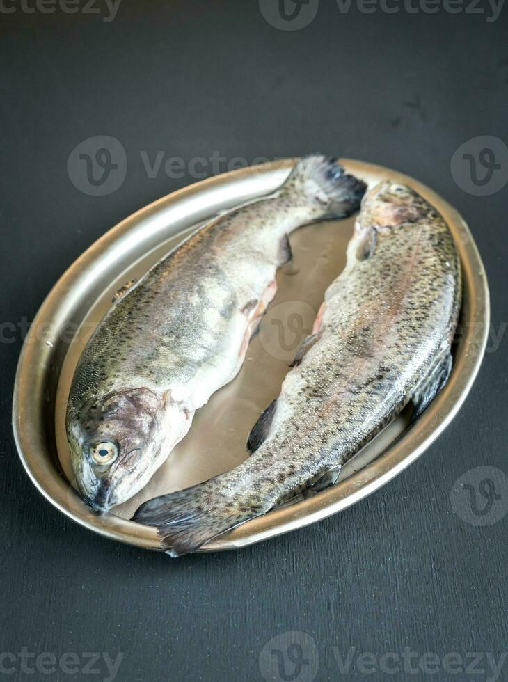 Fresh trouts in ice on the vintage metal tray photo