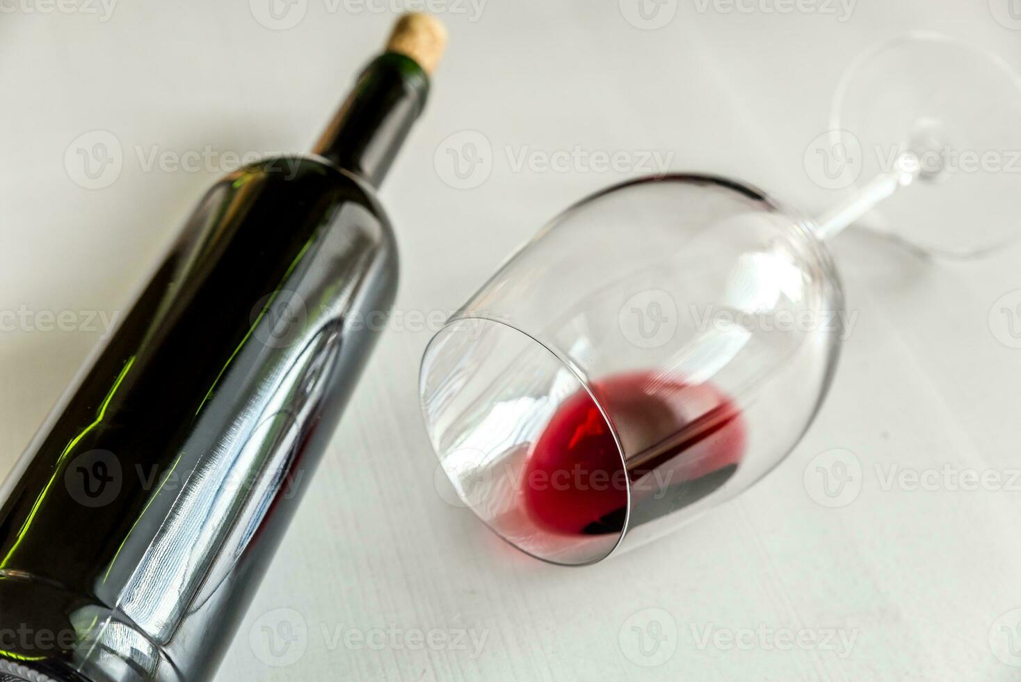 Glass and bottle with red wine photo