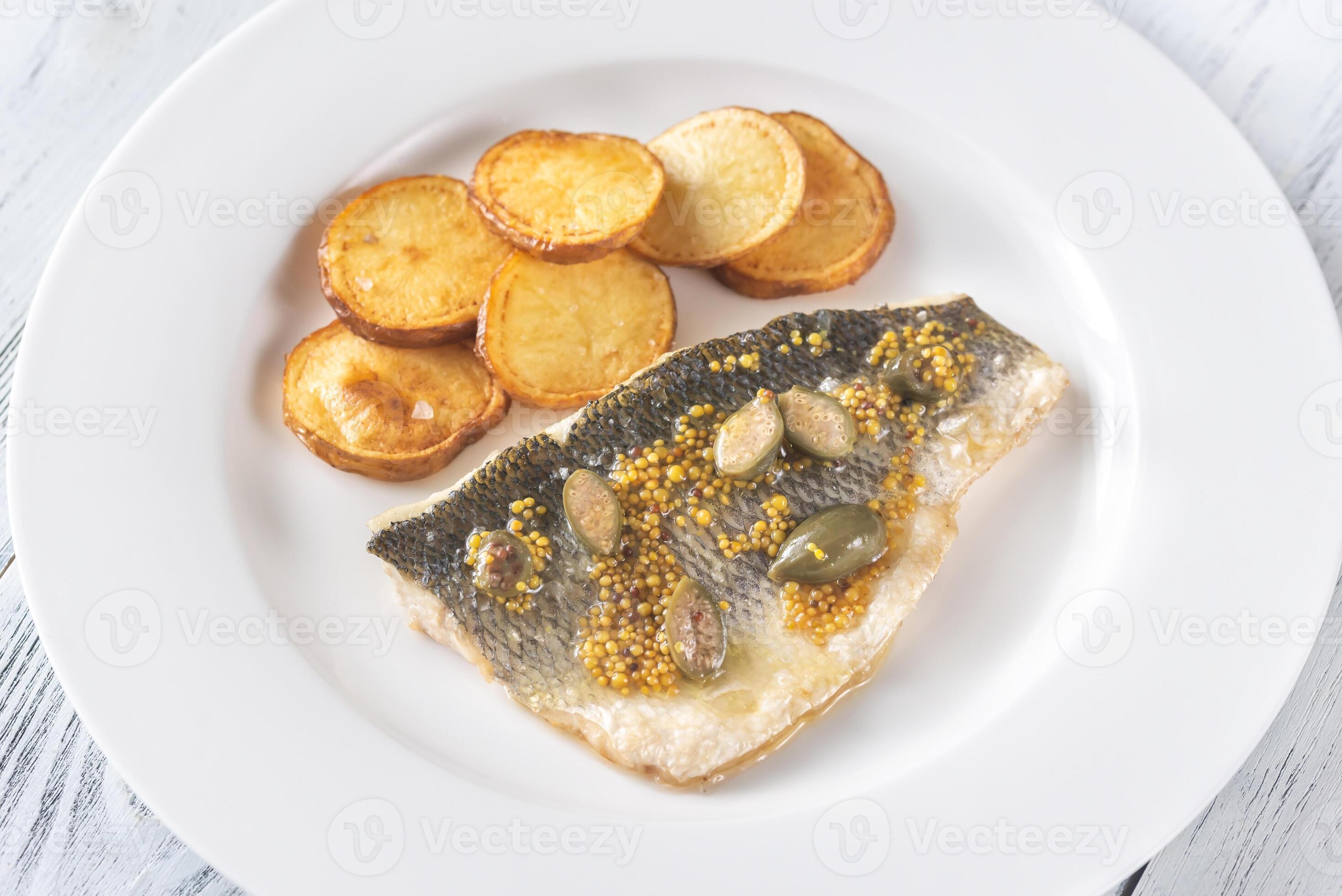 Baked sea bass with capers 27802342 Stock Photo at Vecteezy