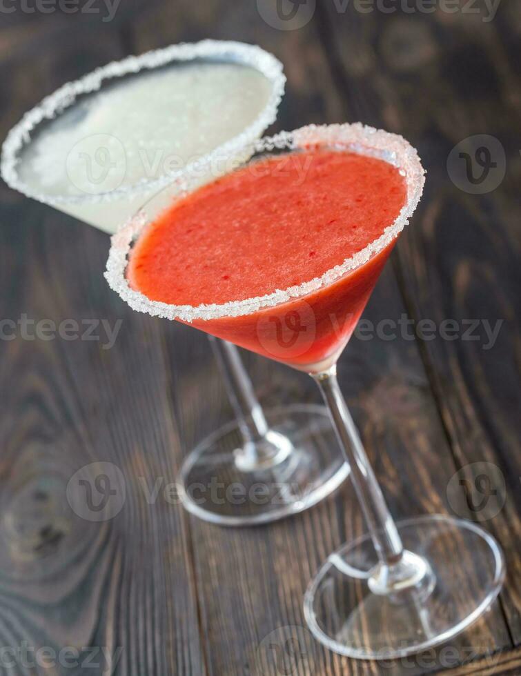 Glasses of lime and strawberry margarita cocktail photo