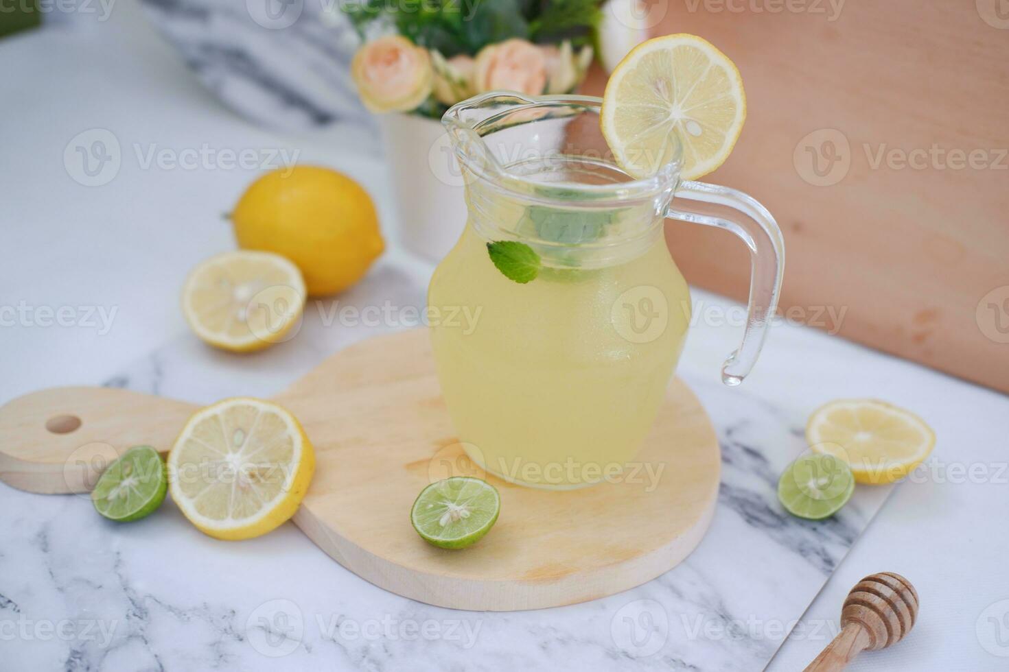 Lemonade with fresh lemon and mint leaves on a white background photo
