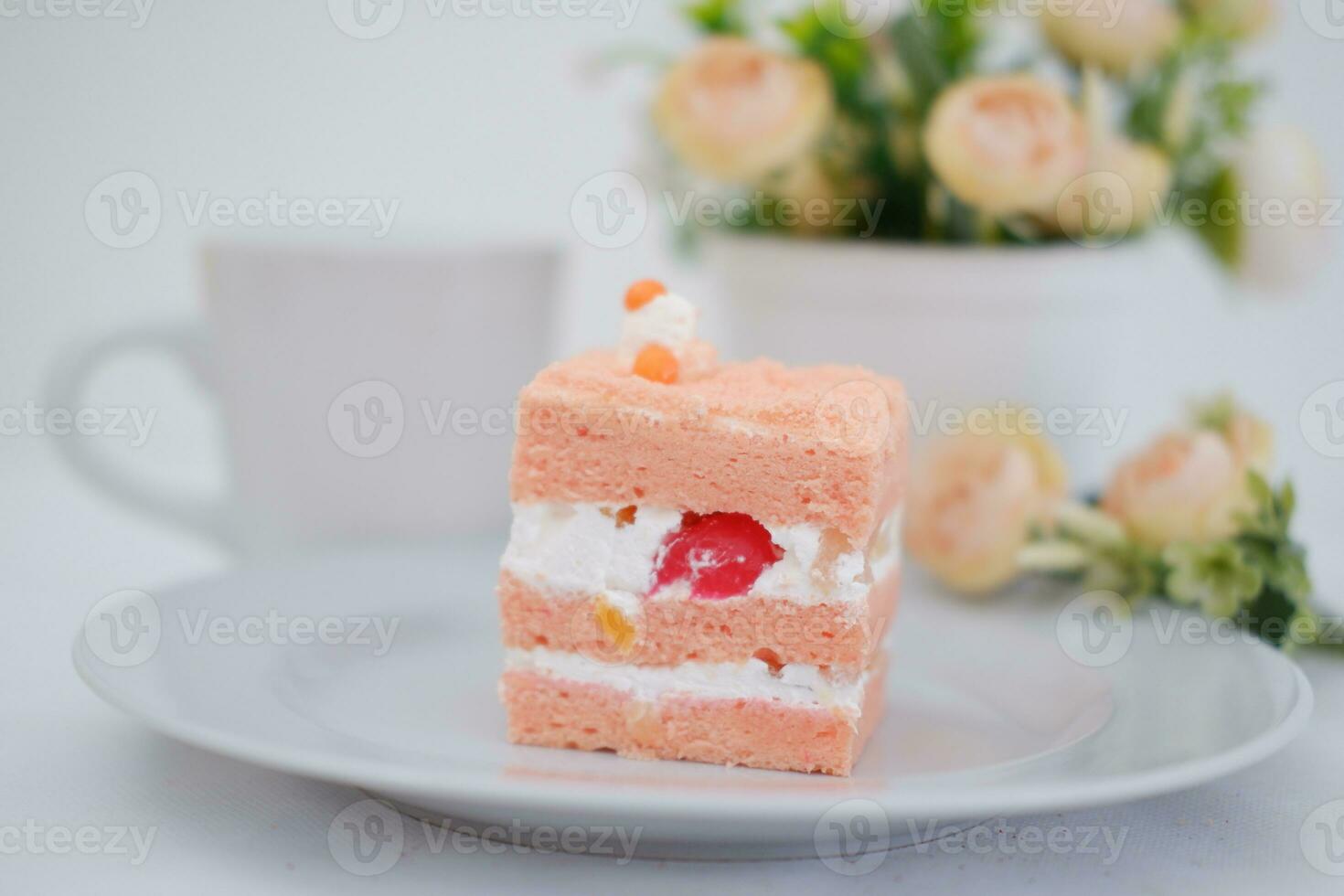 Slice of cake on white marble background. Selective focus. photo