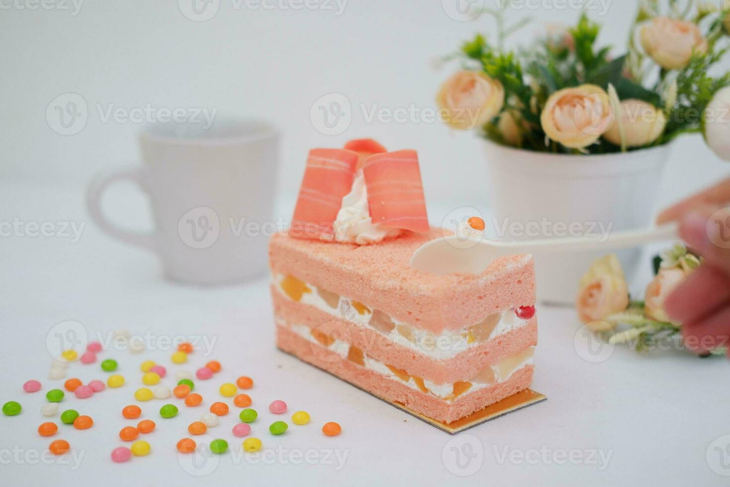 Slice of cake on white marble background. Selective focus. photo