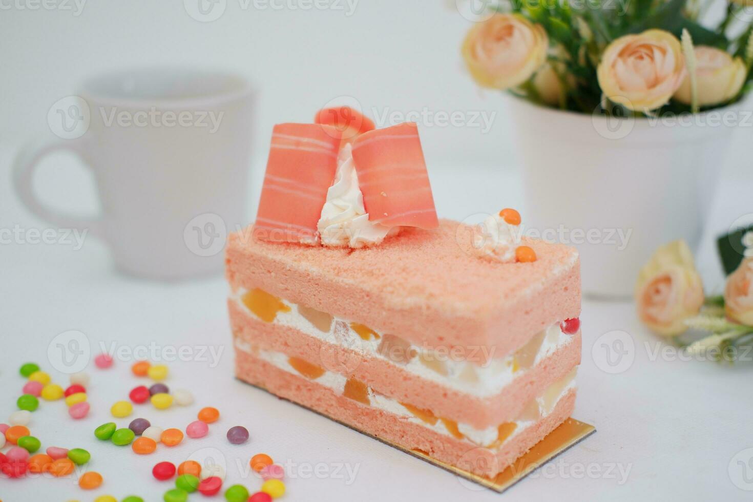 Slice of cake on white marble background. Selective focus. photo