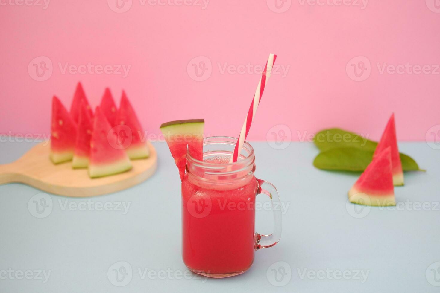 Watermelon smoothie in a glass jar with straws as a background photo