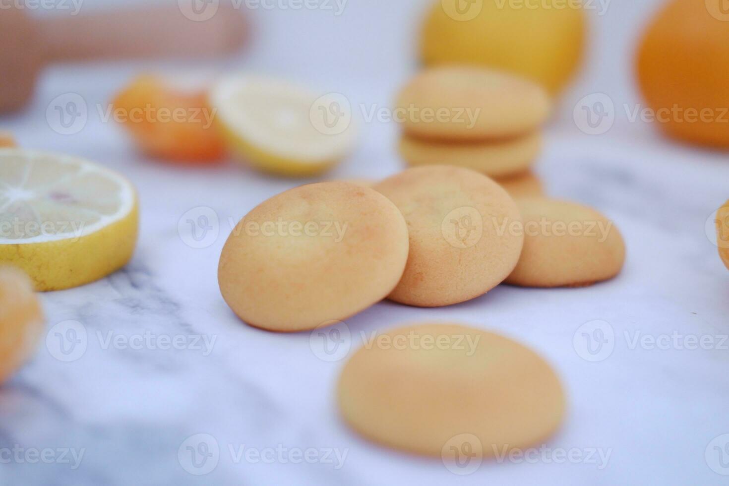 Lemon, orange and lemon slices on a white marble table. photo