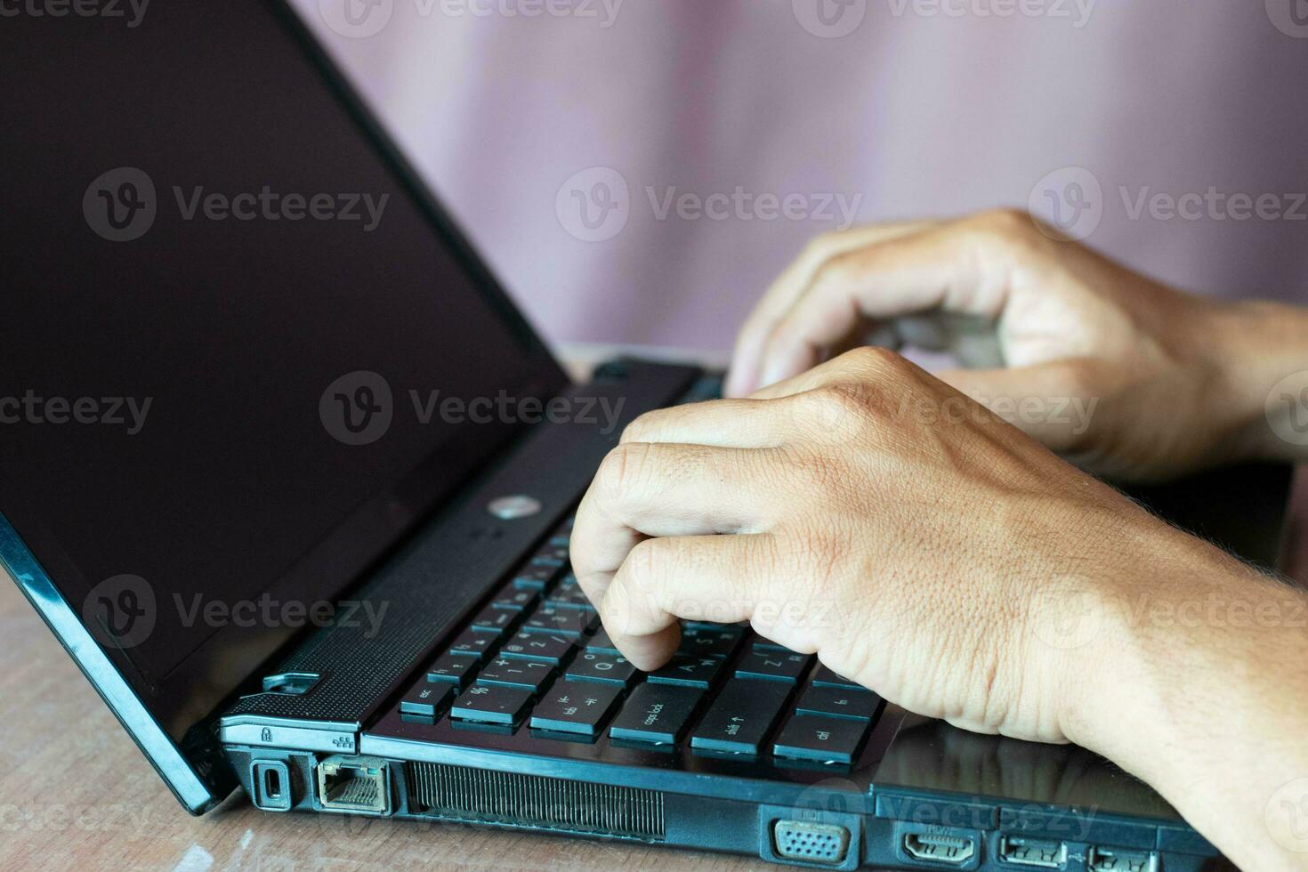 Close-up shot of two male hands working at home with laptop and mobile smart phone, network technology, no thumbs up, great working. photo