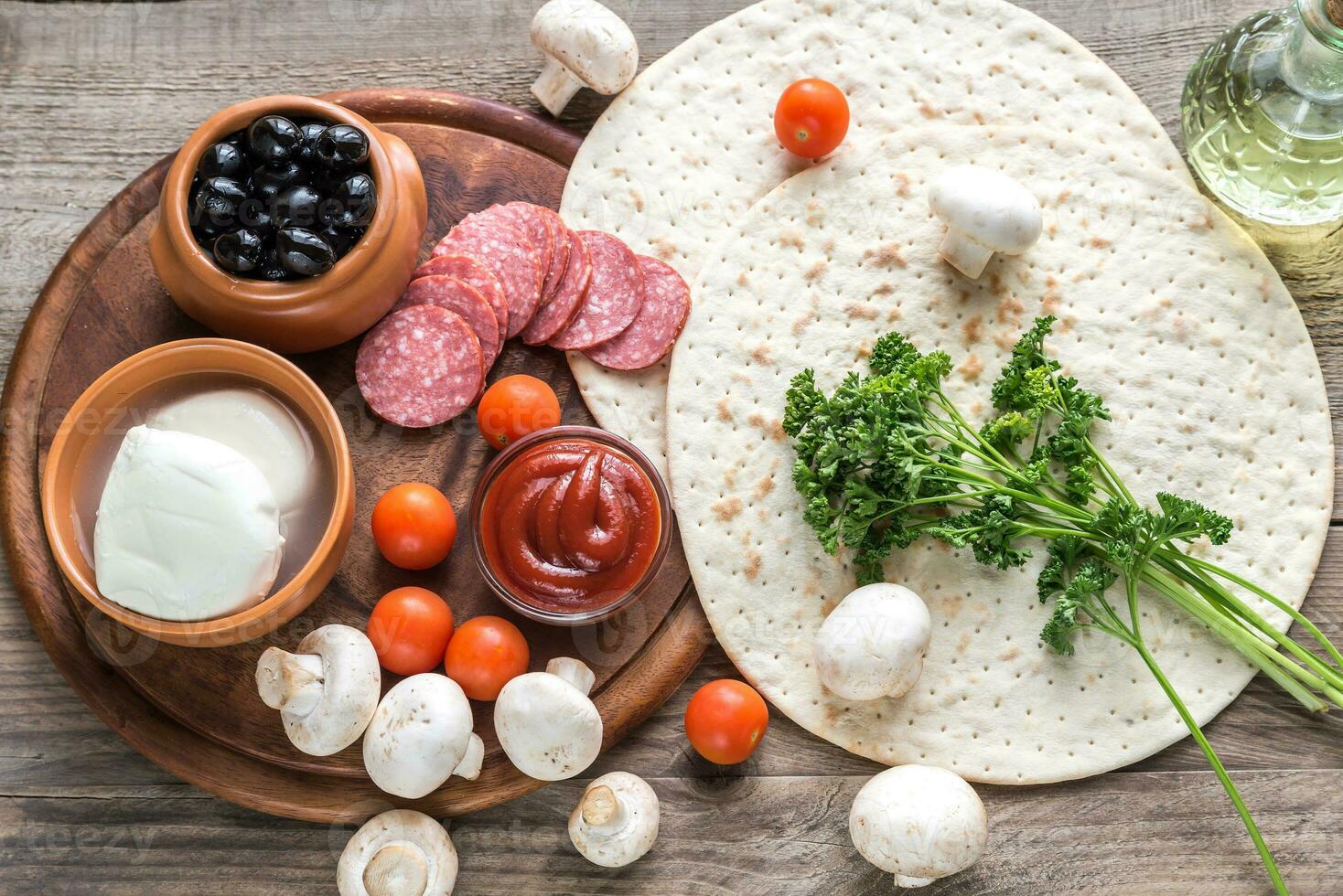 Ingredients for pizza on the wooden background photo