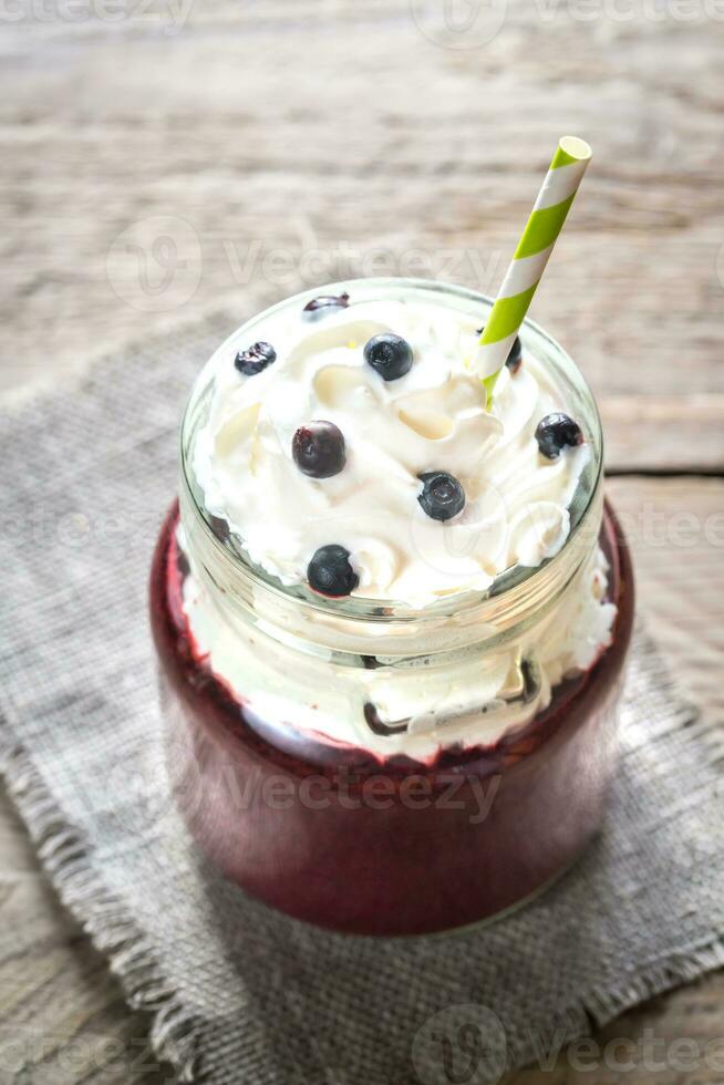 Bilberry smoothie with whipped cream photo