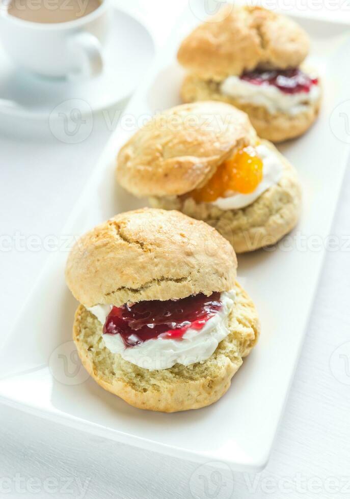 Scones with cream and fruit jam photo