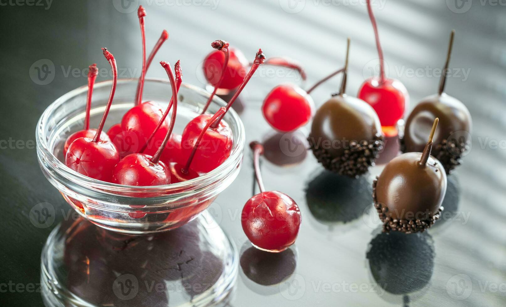 Chocolate and cocktail cherries on the glass photo