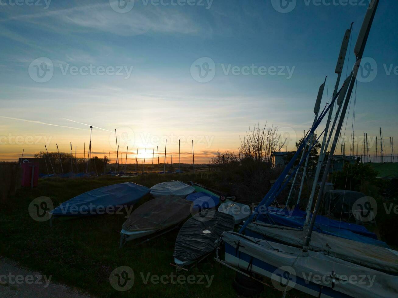 Sailing dinghies and boat masts at sunset photo