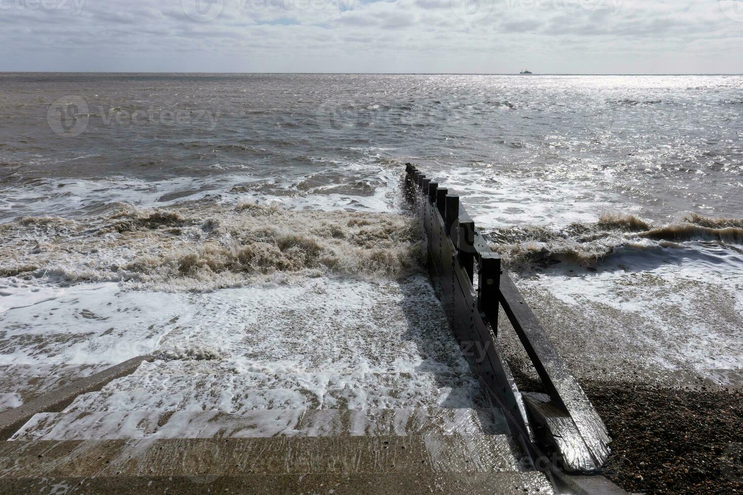 Traditional wooden sea defense groyne photo